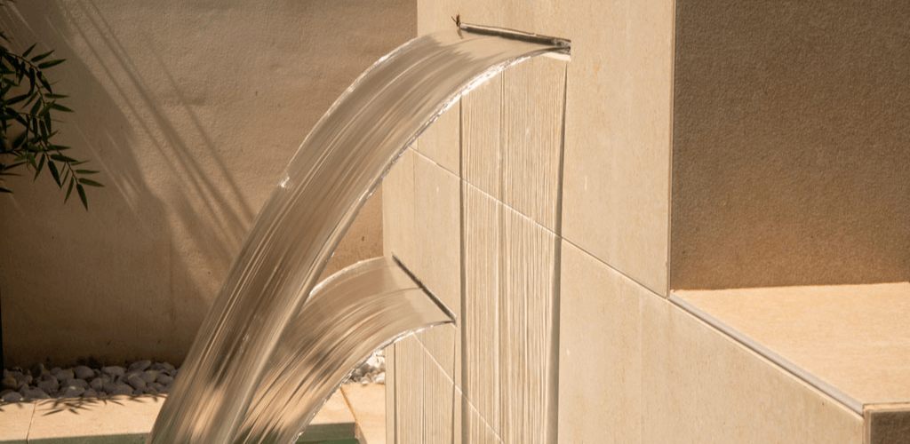 Built-in waterfall integrated into the pool wall