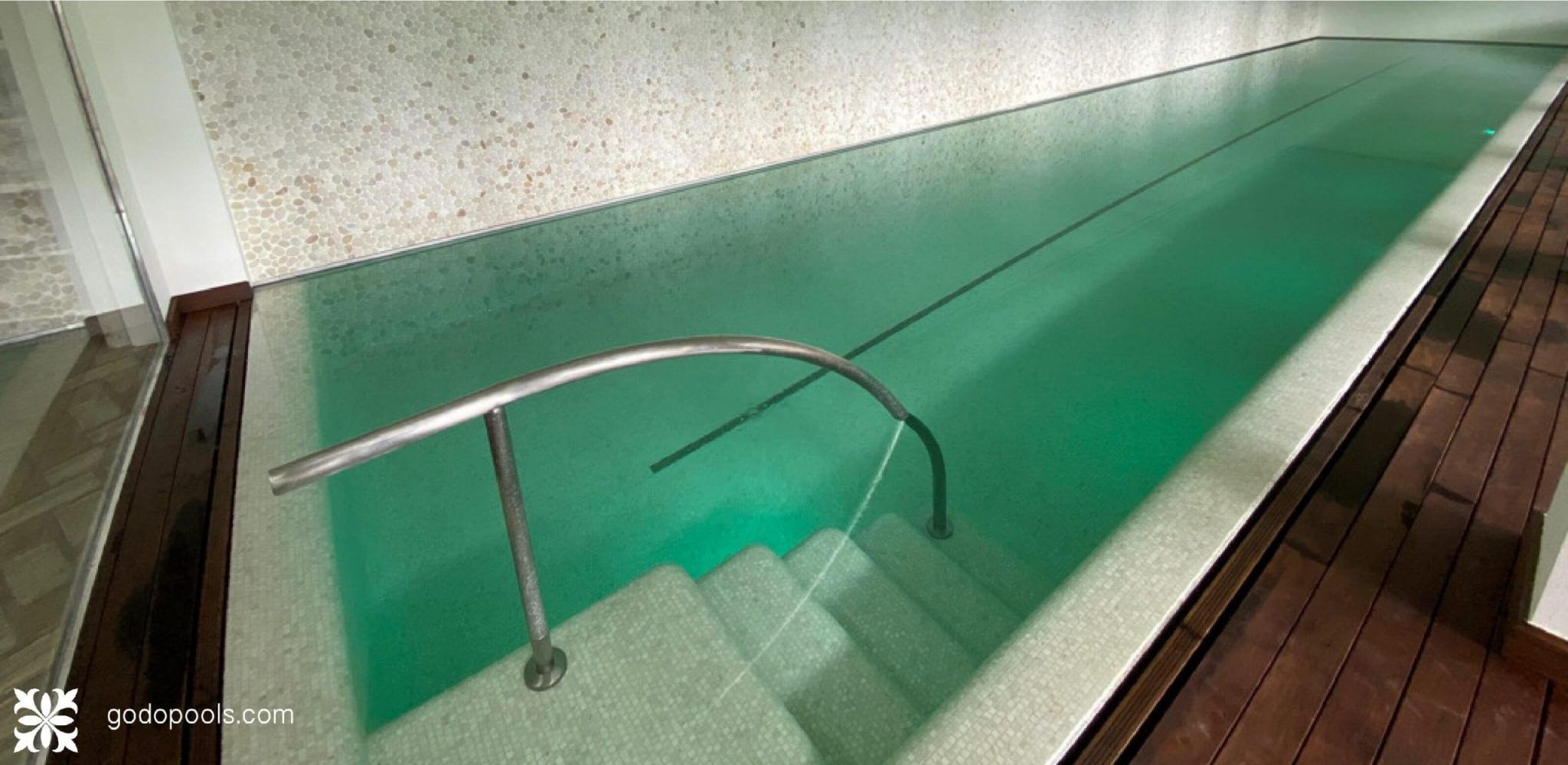 Pool finished with mosaic and wooden floor by GodoPools 