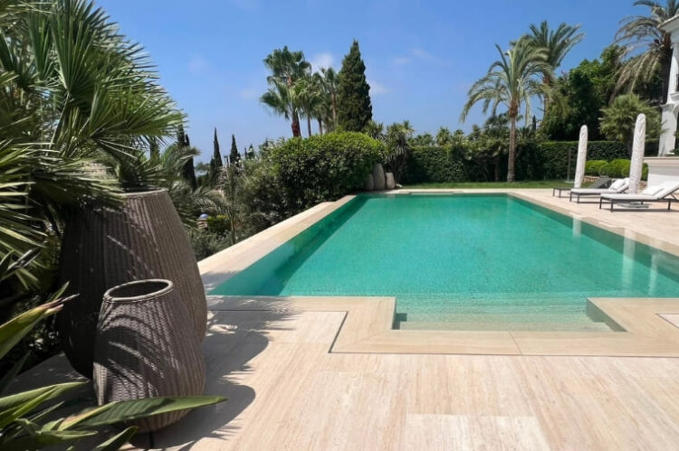 Piscina de lujo revestida en marmol travertino en Marbella por GodoPools
